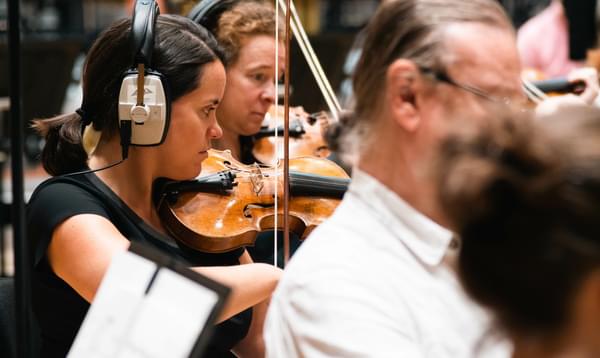 Photograph of Colette Overdijk and violinists wearing headphones whilst recording at CBSO Centre