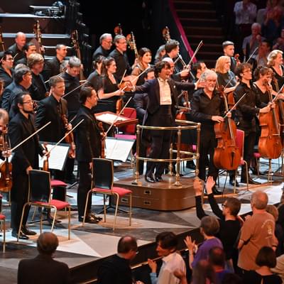 Photograph of Kazuki Yamada and the orchestra receiving a standing ovation at the Royal Albert Hall