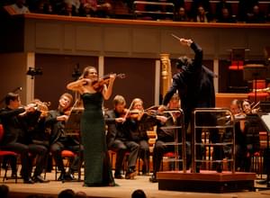 Photograph of Kazuki Yamada and Nicola Benedetti performing with the orchestra at Symphony Hall