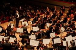 Photograph of Kazuki Yamada conducting the orchestra at Symphony Hall