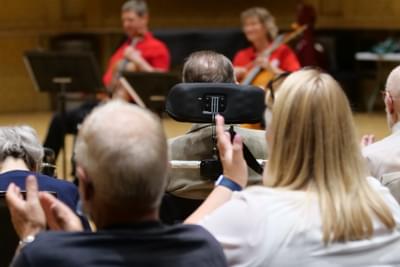 Photograph of audience members applauding at a Cuppa Concert