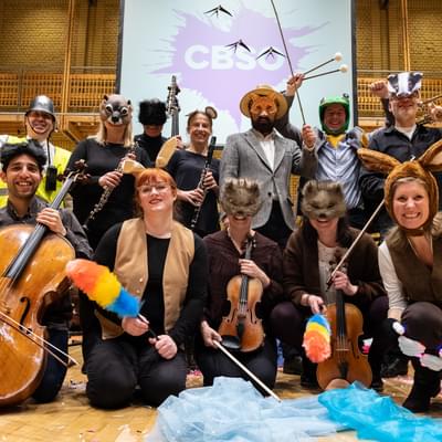 Photograph of musicians in a range of costumes posing for a photograph after a Relaxed Concert
