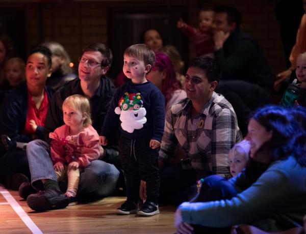 Photograph of families and young children watching a Notelets performance