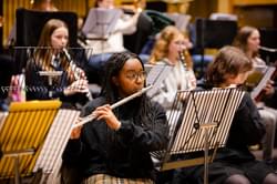 Photograph of a teenage girl playing the flute in a Project Remix rehearsal