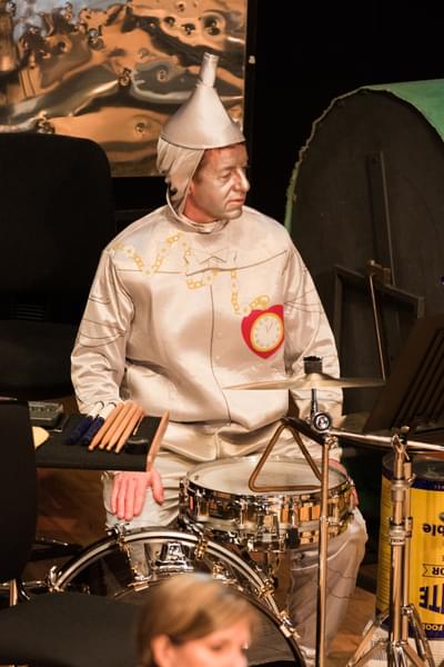 Photograph of Andrew Herbert dressed as the tin man as he plays a drumkit during a Relaxed Concert