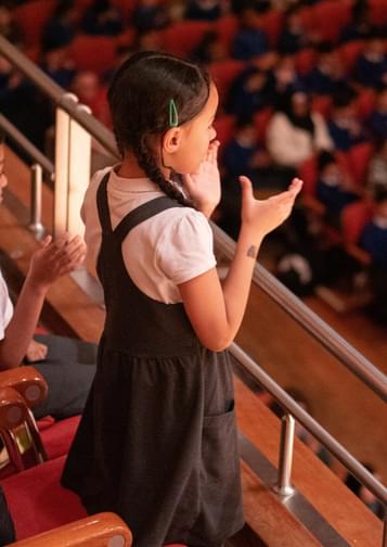 A school child gives a standing ovation at Symphony Hall