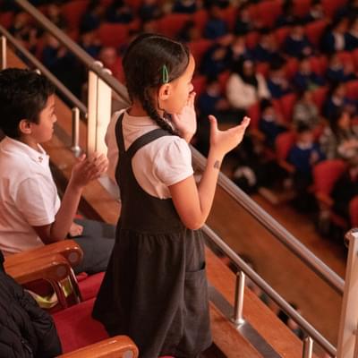 A school child gives a standing ovation at Symphony Hall