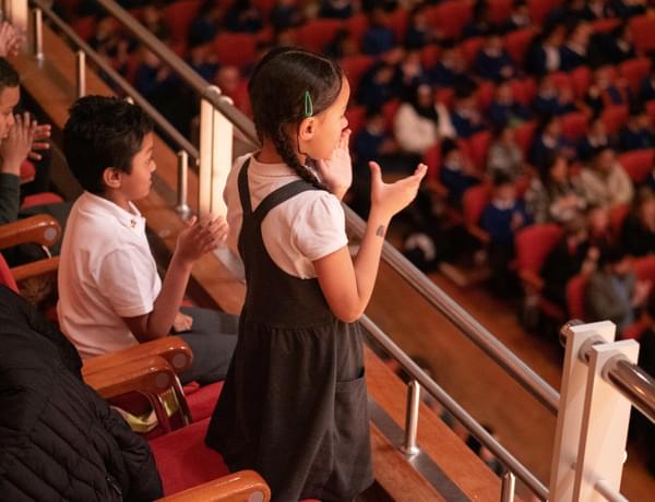 A school child gives a standing ovation at Symphony Hall