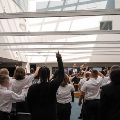 Photograph of children pointing and dancing during a CBSO ensemble performance at the Shireland CBSO Academy