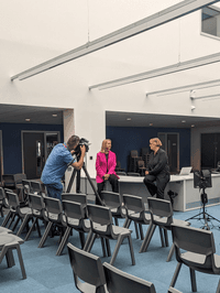Photograph of Emma Stenning filming an interview with BBC News at the Shireland CBSO Academy.