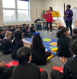 Photograph of CBSO players performing to young children in a school