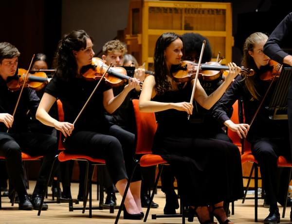 Photograph of violinists performing in the CBSO Youth Orchestra