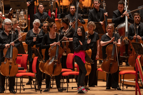 Photograph of Anna Thorvaldsdottir receiving applause with the CBSO.