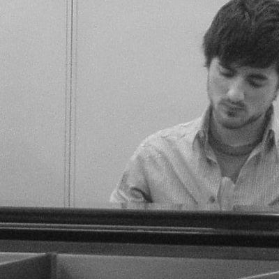 Photograph of James Keefe playing the piano