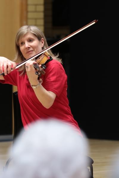 Photograph of Jane Wright playing the violin during a Cuppa Concerts performance
