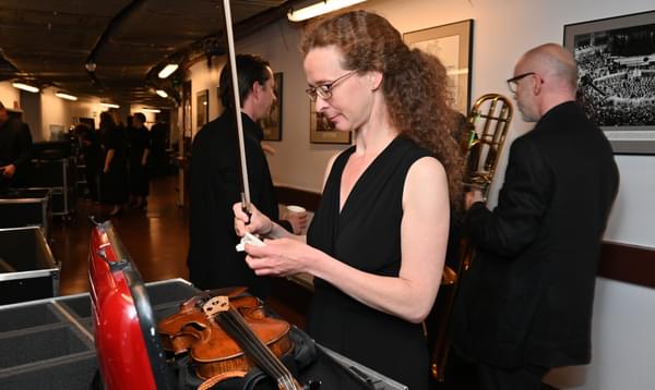 Photograph of Violinist Julia Åberg preparing her bow backstage at the Royal Albert Hall