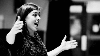 Black and white photograph of Lucy Hollins conducting