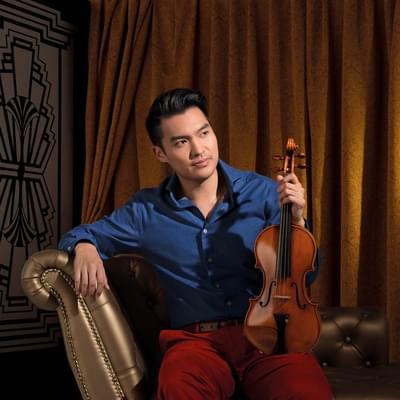 Photograph of Ray Chen holding his violin.