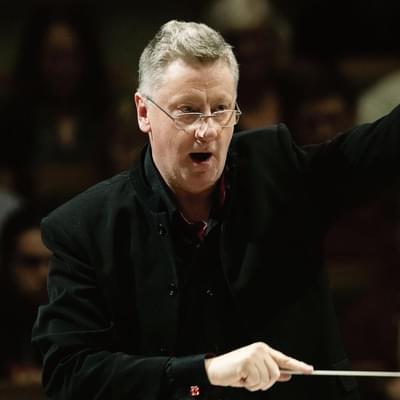 Photograph of Stephen Bell conducting.