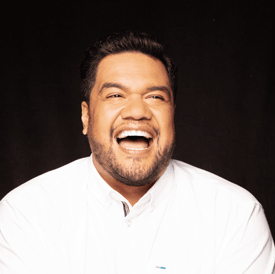 Photograph of tenor Pene Pati laughing.