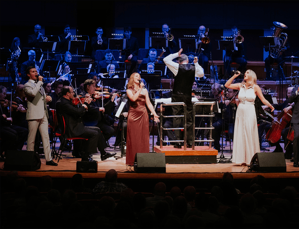Photograph of singers performing in front of the CBSO at Symphony Hall