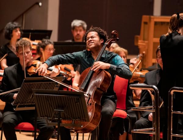 Photograph of Sheku Kanneh-Mason playing the cello with the CBSO at Symphony Hall.