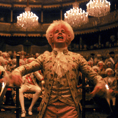 A still taken from the film Amadeus showing Mozart in a grand hall.