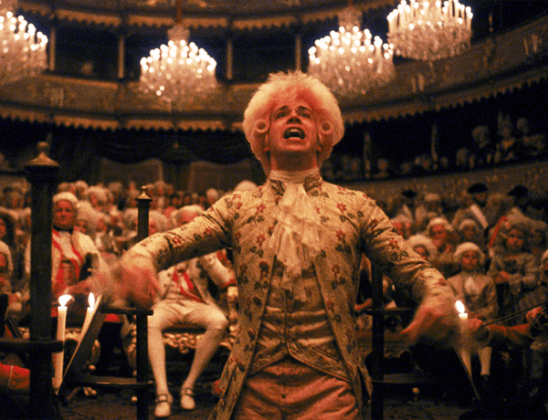 A still taken from the film Amadeus showing Mozart in a grand hall.