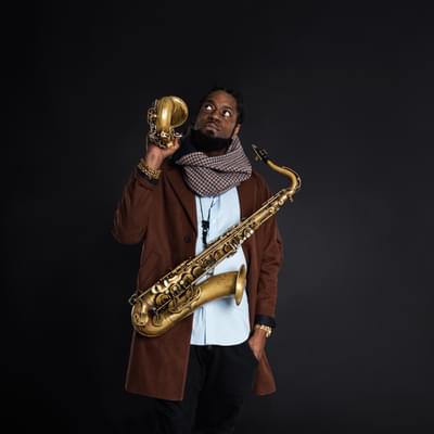 Photo of Soweto Kinch holding two saxaphones