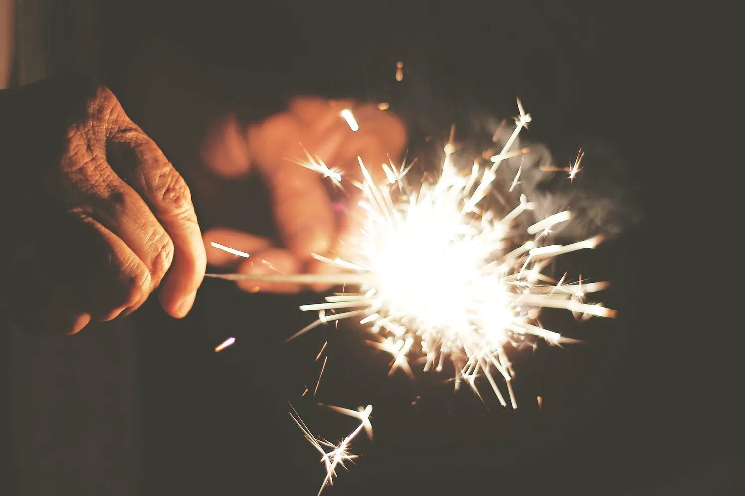 Old hand holds sparkler