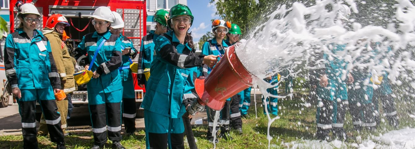 A CLS Russian student holds a fire hose during an excursion.