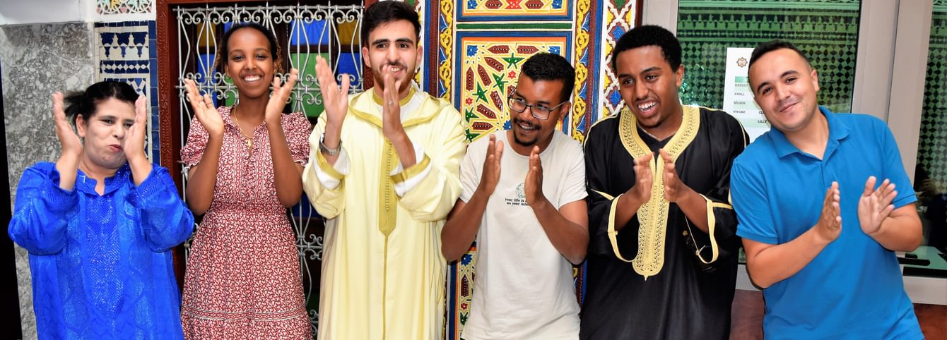 CLS Arabic participants clap to music during a celebration in Morocco.