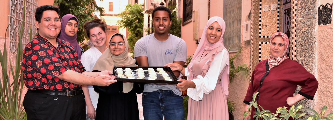 CLS Arabic participants show off Moroccan sweets they baked during a cultural activity.
