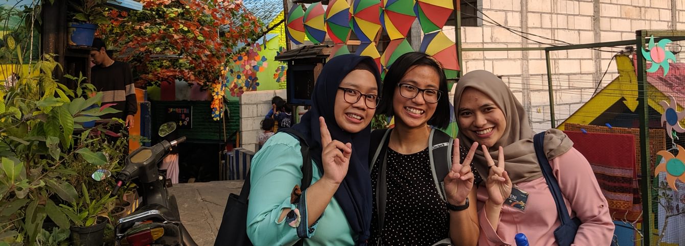 Joy and her language tutors at Kampung Warna-Warni