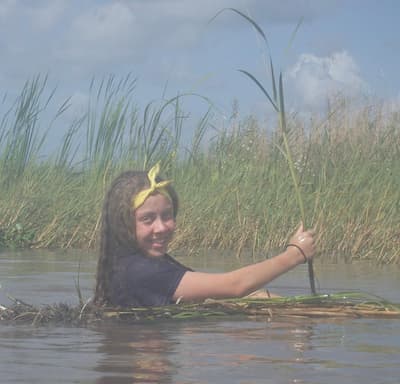 Bridget in a plant marsh as part of her volunteer work educating the public on Louisiana's wetlands.