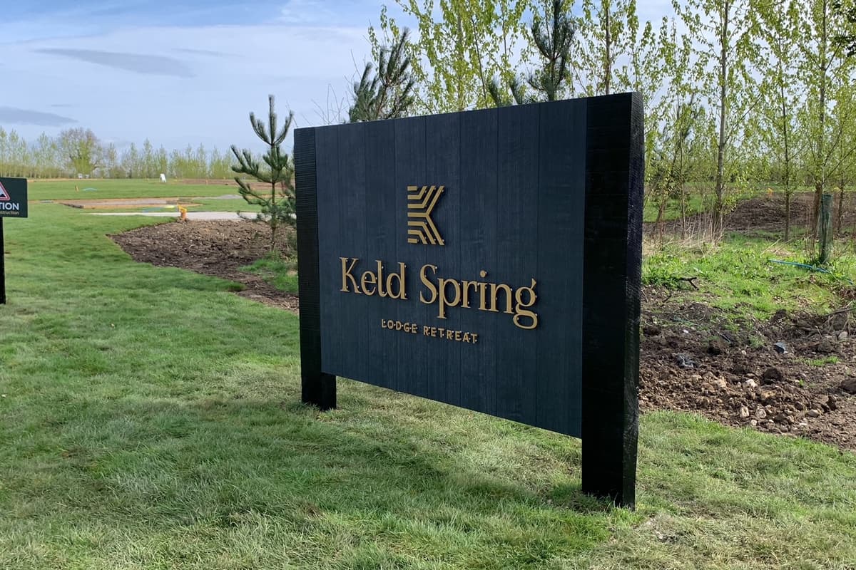 Keld Spring - Lodge Retreat entrance sign with trees in the background | Coming soon … Keld Spring, a new concept in luxury staycation retreats