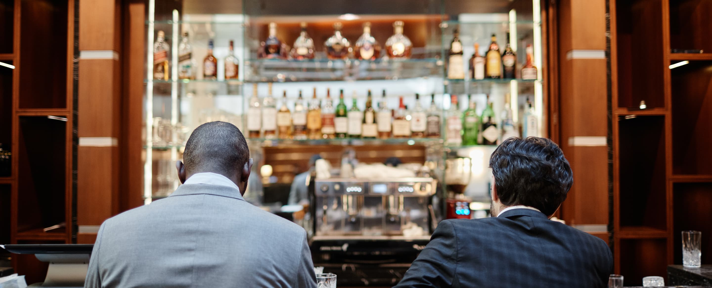 Business people at bar counter back view J26 CKPG