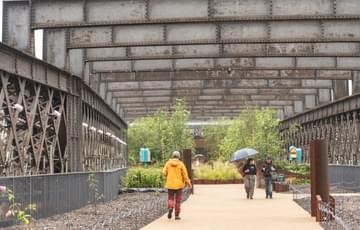 An industrial railway line transformed into a garden, with people walking along