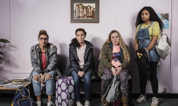 A group of women wait anxiously in a hospital waiting room