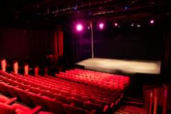 The stage and the red seats in the main auditorium space 1, with the stage at the bottom