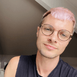 A white male with pink hair and glasses