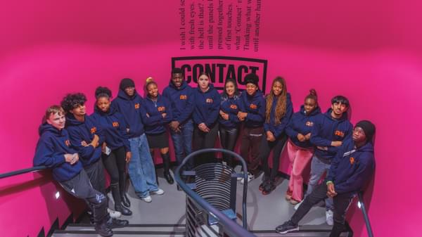 A big group of people - Agents and panellists - stand on Contact's stairwell