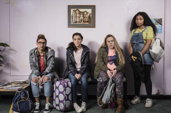 A group of young women sit in a doctors office
