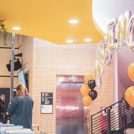 Contact's lower foyer dressed in orange, black and silver balloons