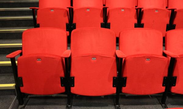 A close-up of three seats from the central seating bank, the left seat is next to the aisle.