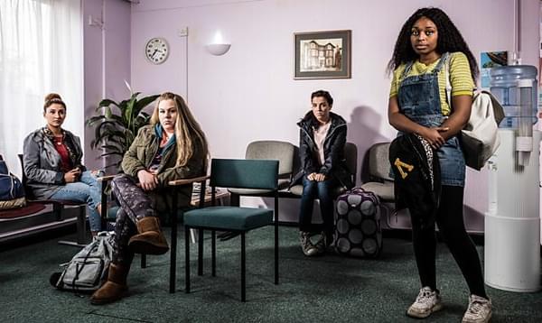 A group of women wait anxiously in a hospital waiting room