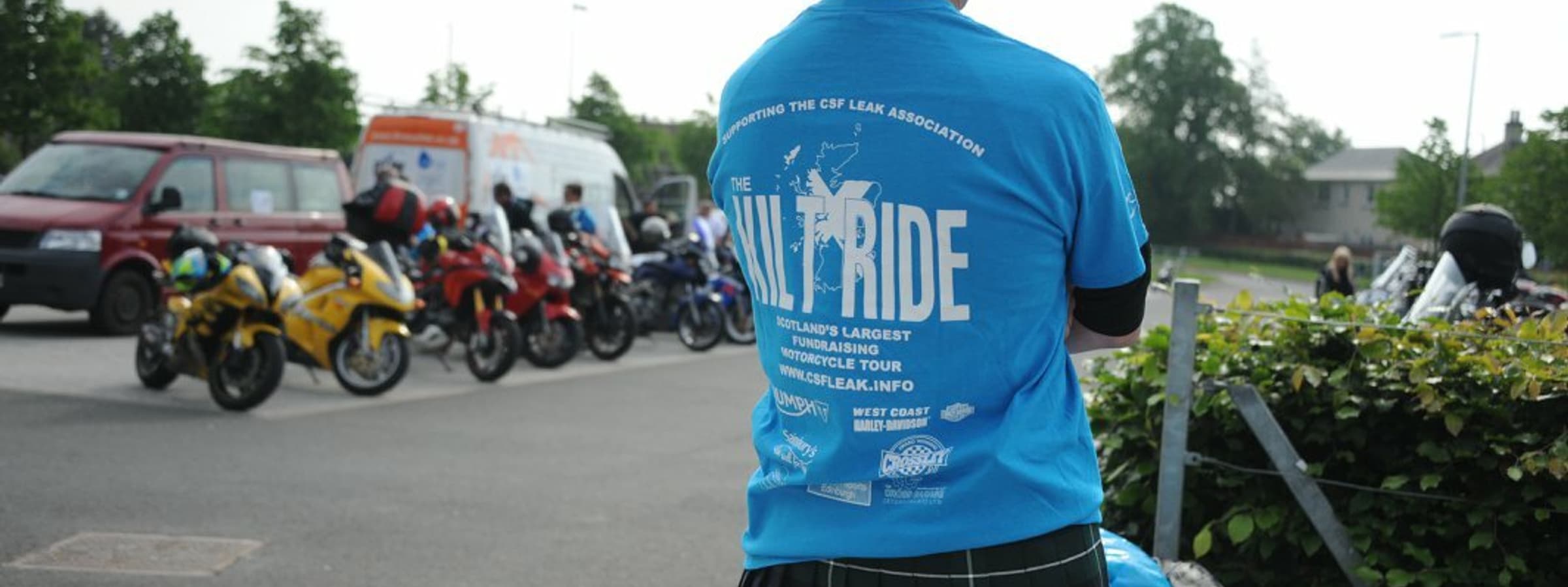 A man from behind wearing a kilt and a shirt that says "Kilt Ride".