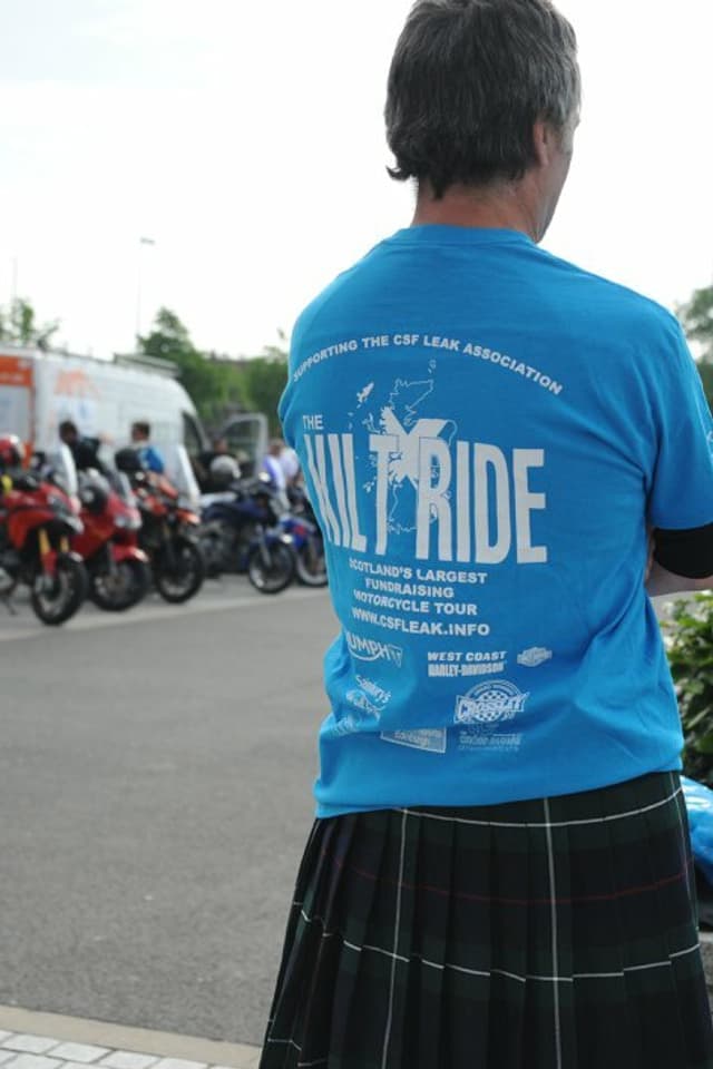 A man from behind wearing a kilt and a shirt that says "Kilt Ride".