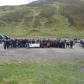 Group photo of some people in kilts holding a CSF Leak Association banner.