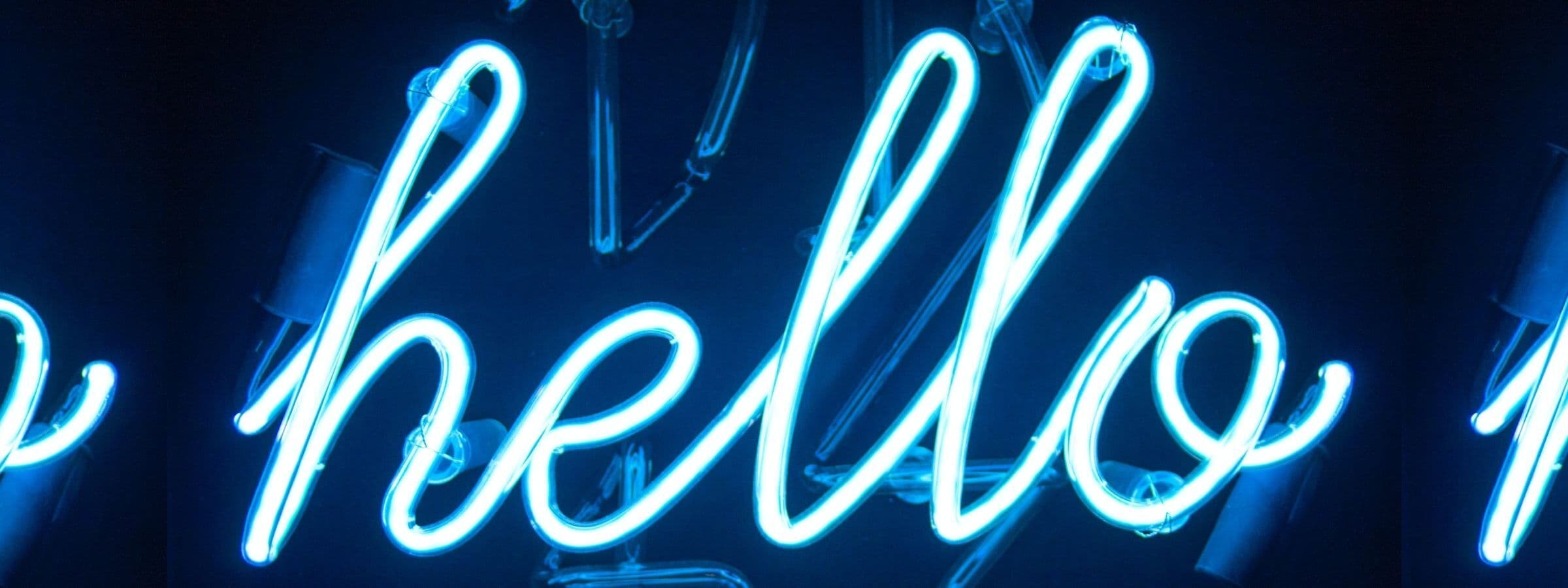 A neon sign that says "hello" in cursive.